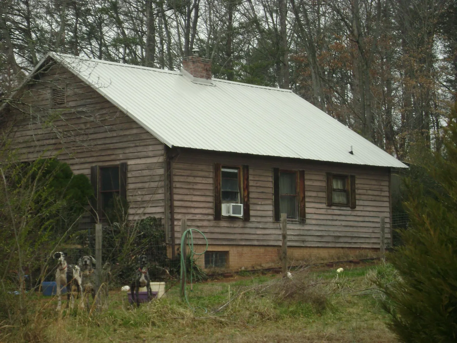 White metal roof on an old wood sided farmhouse, from a Metal Roof Installation job in Rock Port